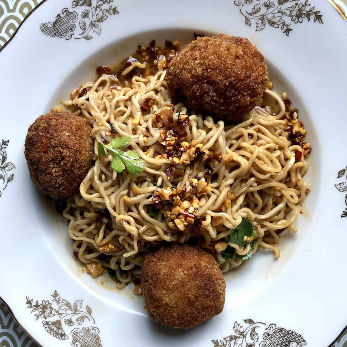 Homemade Sichuan style noodles with fresh ramen noodles and crispy fried panko-crusted pork meatballs showing Chinese noodles recipe and how to use these ramen noodles.