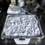 Tray of homemade baked baking soda on aluminum foil lined sheet pan for making alkaline ramen noodles recipe sodium carbonate preparation how to make baked baking soda ramen ingredients essential alkaline mineral kansui substitute.