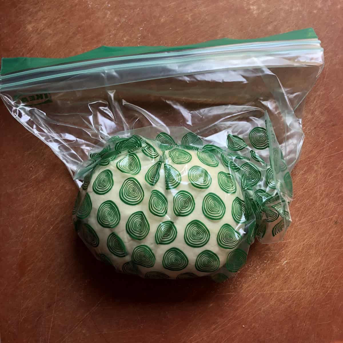 How to make udon noodles showing fresh udon dough ball placed in plastic bag before foot kneading homemade udon noodles recipe first step for thick udon noodles from scratch without pasta machine (same process for making ramen noodles without a pasta machine.