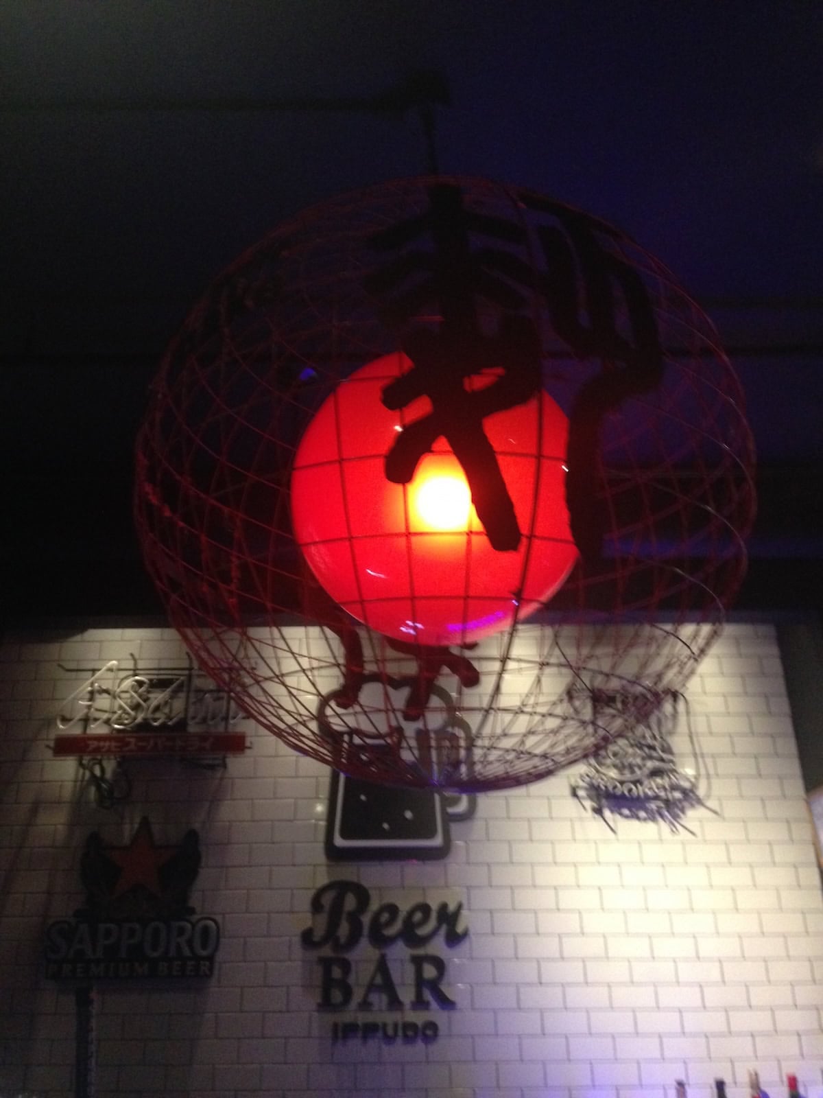 Inside Ippudo ramen shop in NYC East Village showing bar area where customers wait to be seated due to long lines in this famous ramen restaurant showing how the New York ramen dining experience really is..a super popular ramen restaurant.