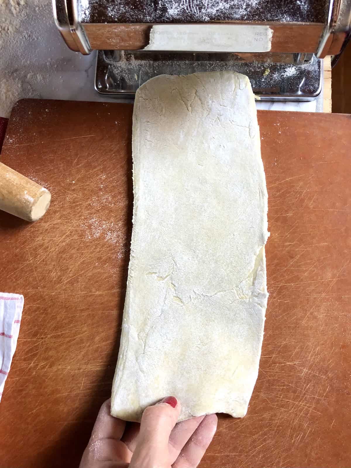 Ramen dough after first roll through pasta machine on widest setting homemade ramen noodles recipe alkaline dough sheeting process how to make ramen rolling technique pasta machine first pass flattening dough.