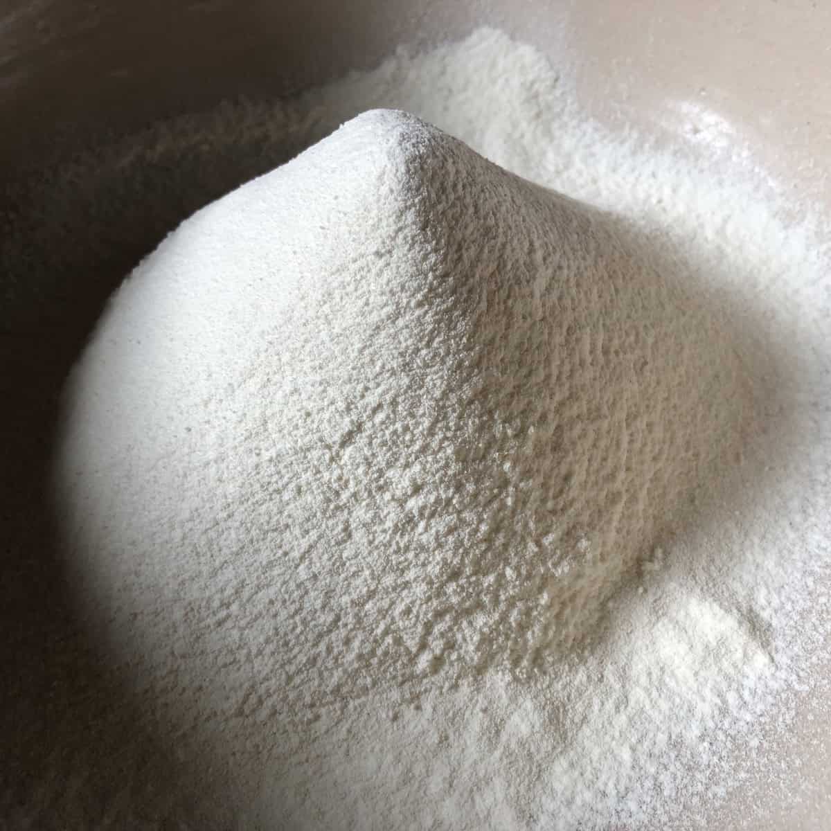 Sifted bread flour for ramen noodles showing fine smooth texture after sifting homemade ramen noodles recipe high protein flour preparation how to make ramen ingredients sifted flour for alkaline noodles smooth consistent texture.