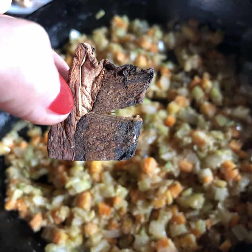 adding the porcini mushroom to the skillet