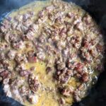 Italian pork sausage, cubed ventricina salami, tiny diced carrots, onoions, garlic, dried sage leaves sautéing in a cast iron skillet after being deglazed with red wine and a little heavy cream added turning the sauce a beautiful almost turmeric color.