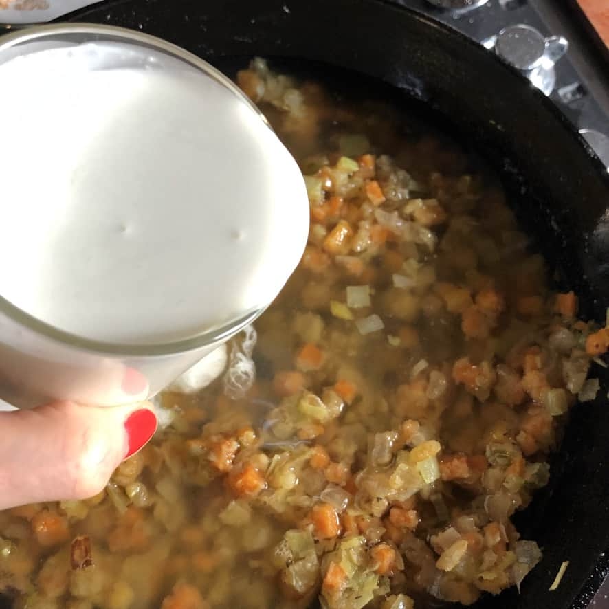 adding heavy cream and milk to mixture