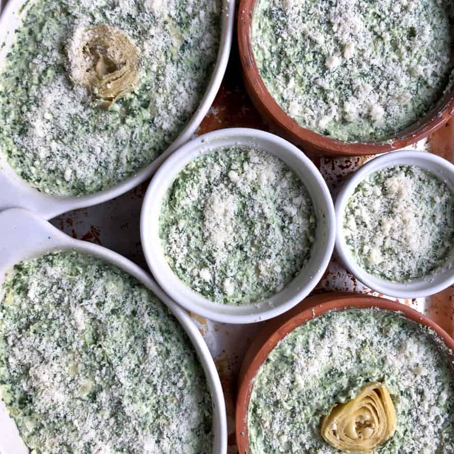 assembled unbaked dip that's been sprinkled with more grana padano cheese