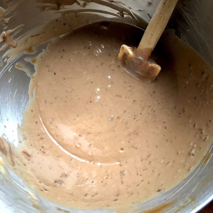 milk-chocolate caramel cheesecake batter in the mixing bowl