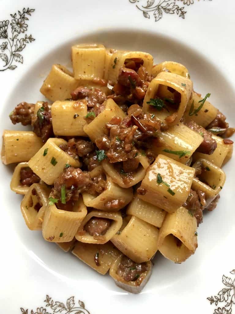 square pasta with sausage and with chopped chives sprinkled on top