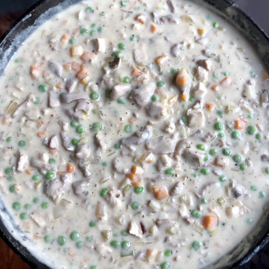 Creamy turkey pot pie filling mixed together and thickened perfectly and ready to be added to the pie plate