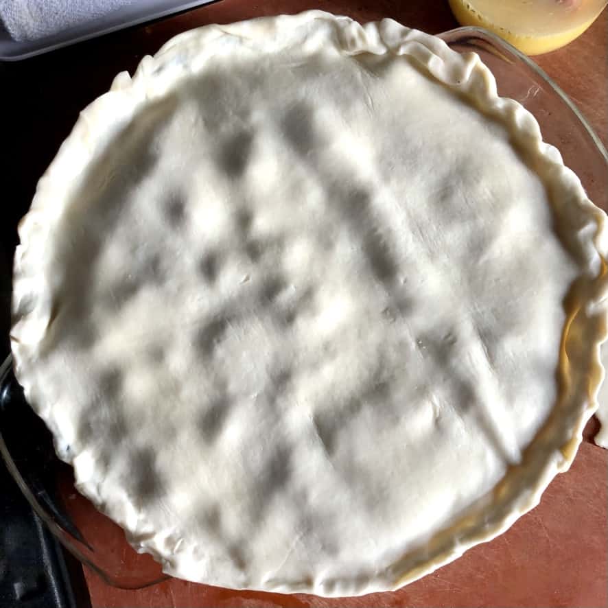 dough added to the top of the pot pie and pinched and crimped