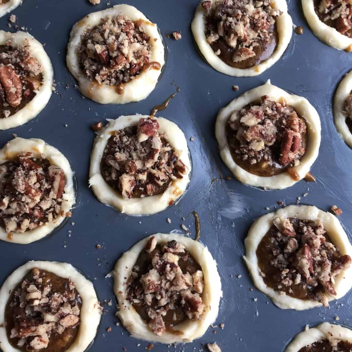 pecan tassies filled and sprinkled with more pecans