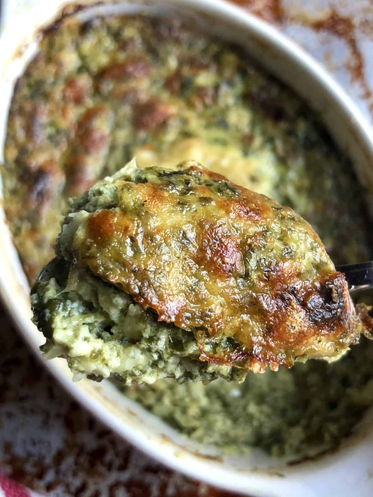 a hot spoonful of golden brown bubbly spinach artichoke dip