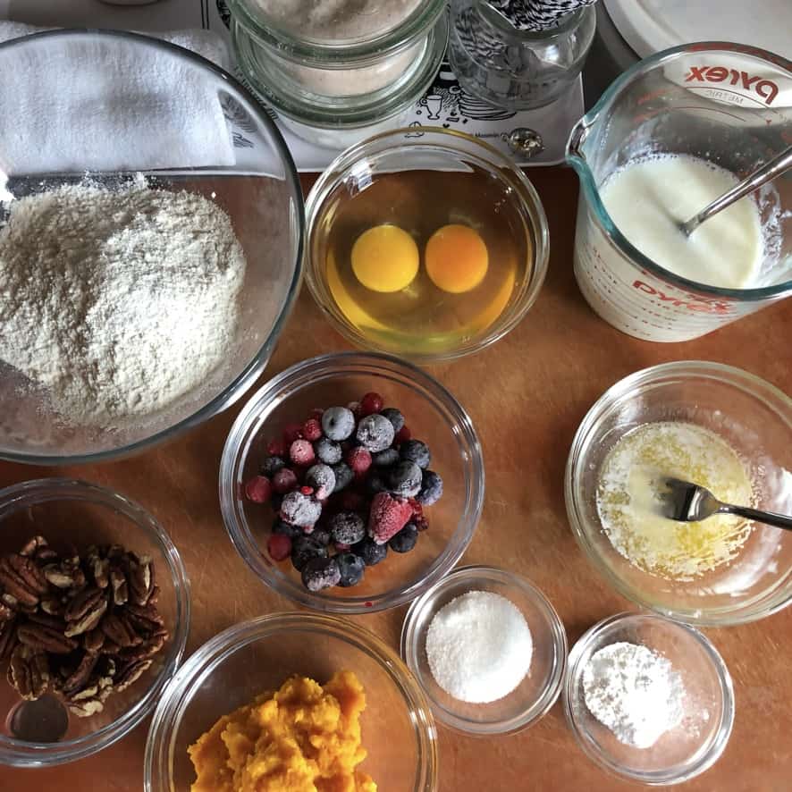 pumpkin pancake with wild berries and pecans ingredients on a cutting board