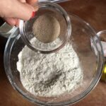 adding yeast to the flour mixture
