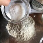 adding sugar and salt to flour