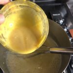 adding the tempered yolks to the milk mixture
