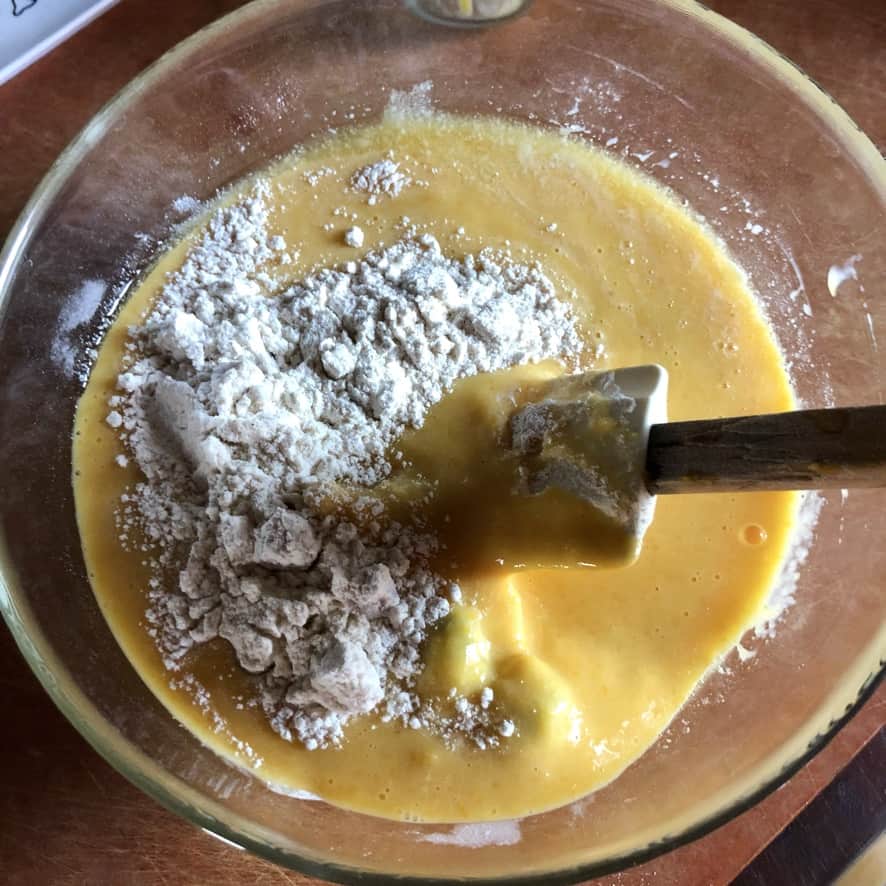 stirring the wets and dries using a rubber spatula