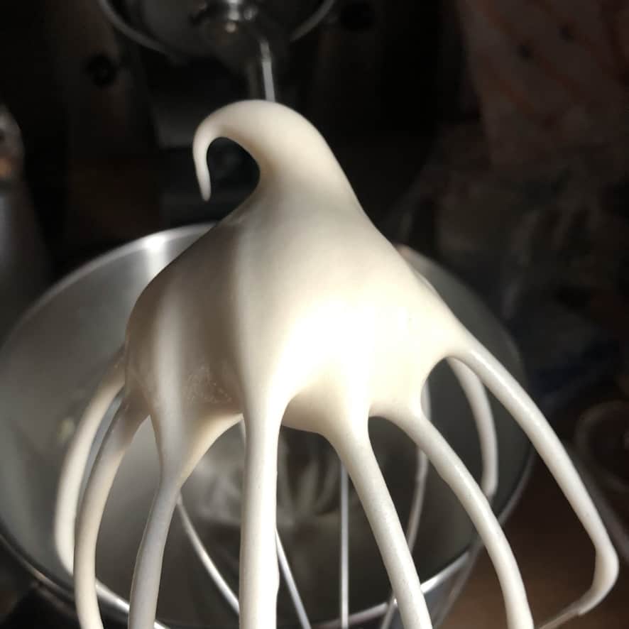 the meringue holding stiff peaks on the end of a beater