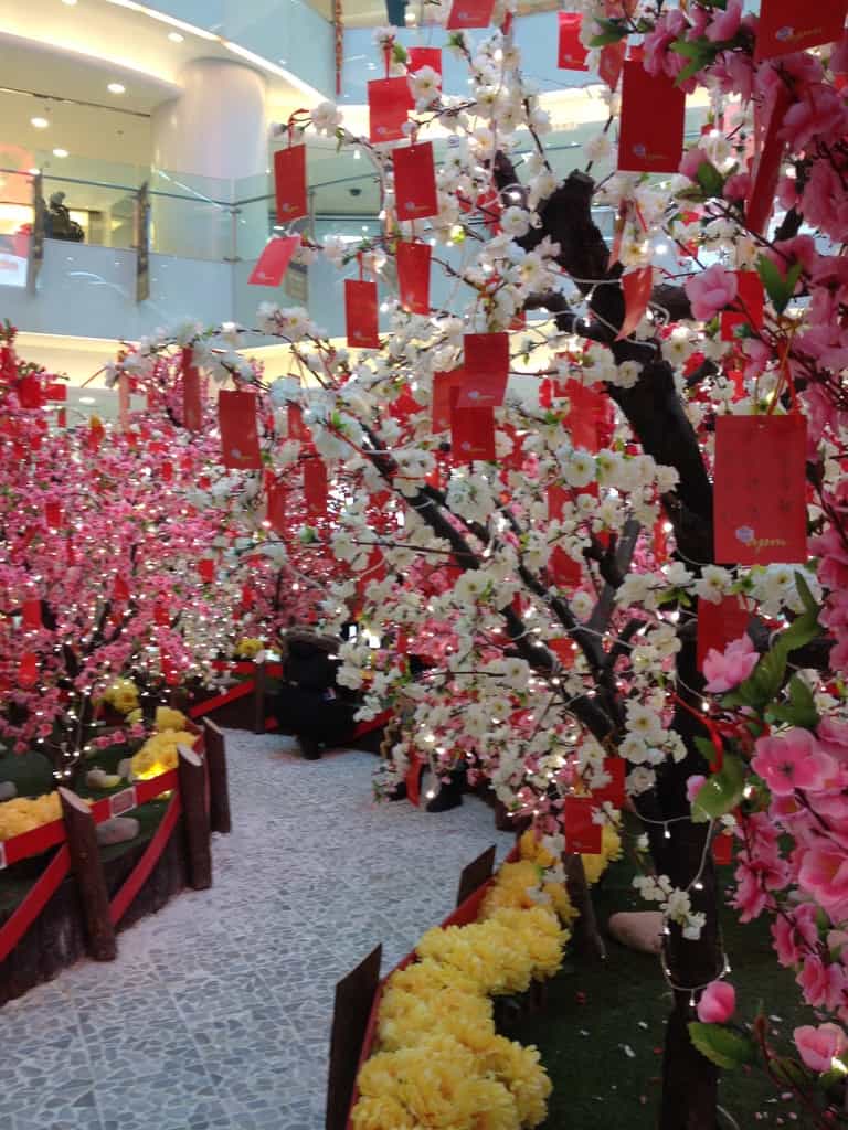 Inside a mll in Beijing with a Chinese New year display with red packets and flowers everywhere -- Beijing, China