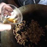 deglazing the chicken and pork mixture with shaoxing wine