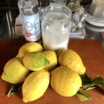 Homemade limoncello ingredients on a cutting board