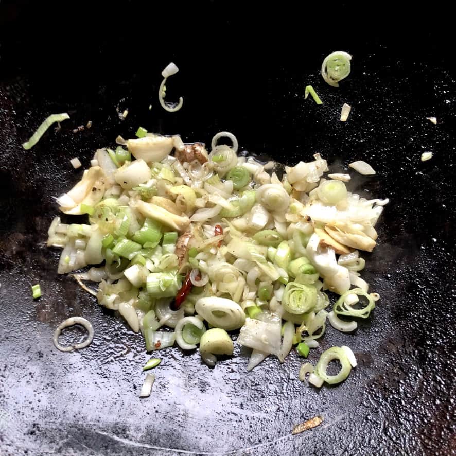 garlic, ginger, scallions, onions added to the wok