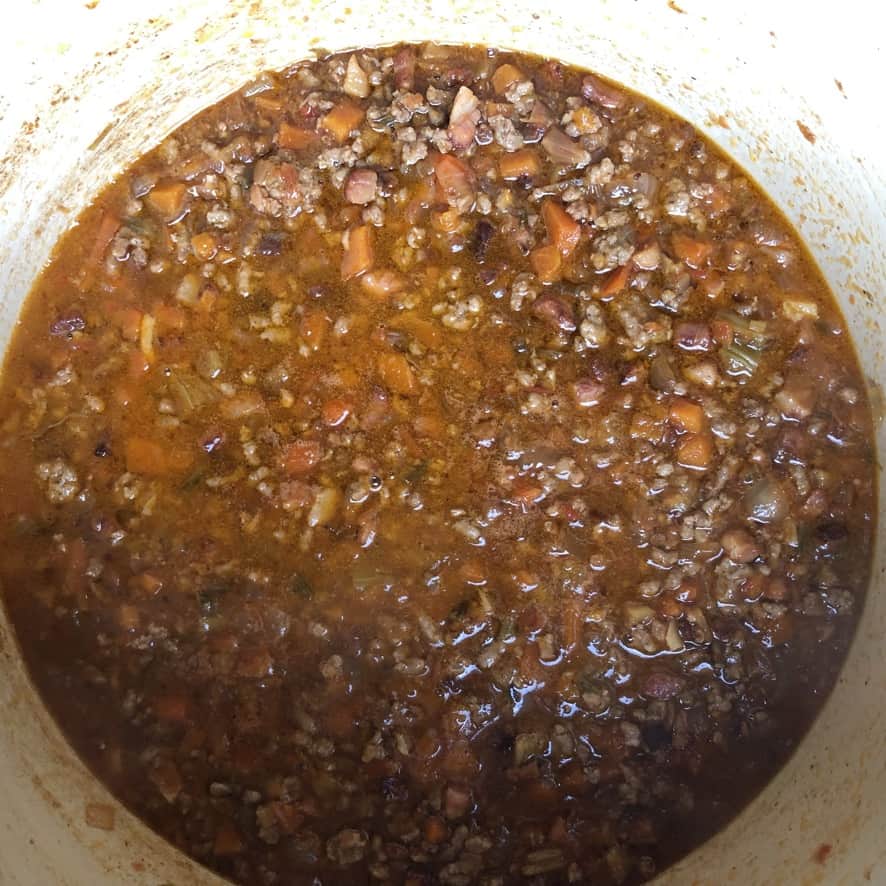 ragu bolognese in a le creuset dutch oven.