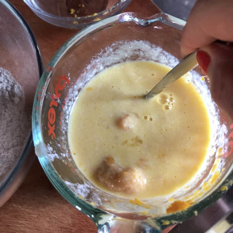 whisking the buttermilk, egg, pumpkin mixture together