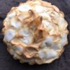 beautifully golden brown toasted coconut cream pie with large pieces of hand shaved coconut on meringue topping