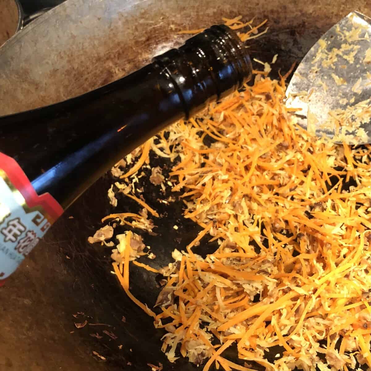 Deglazing the wok with shaoxing wine