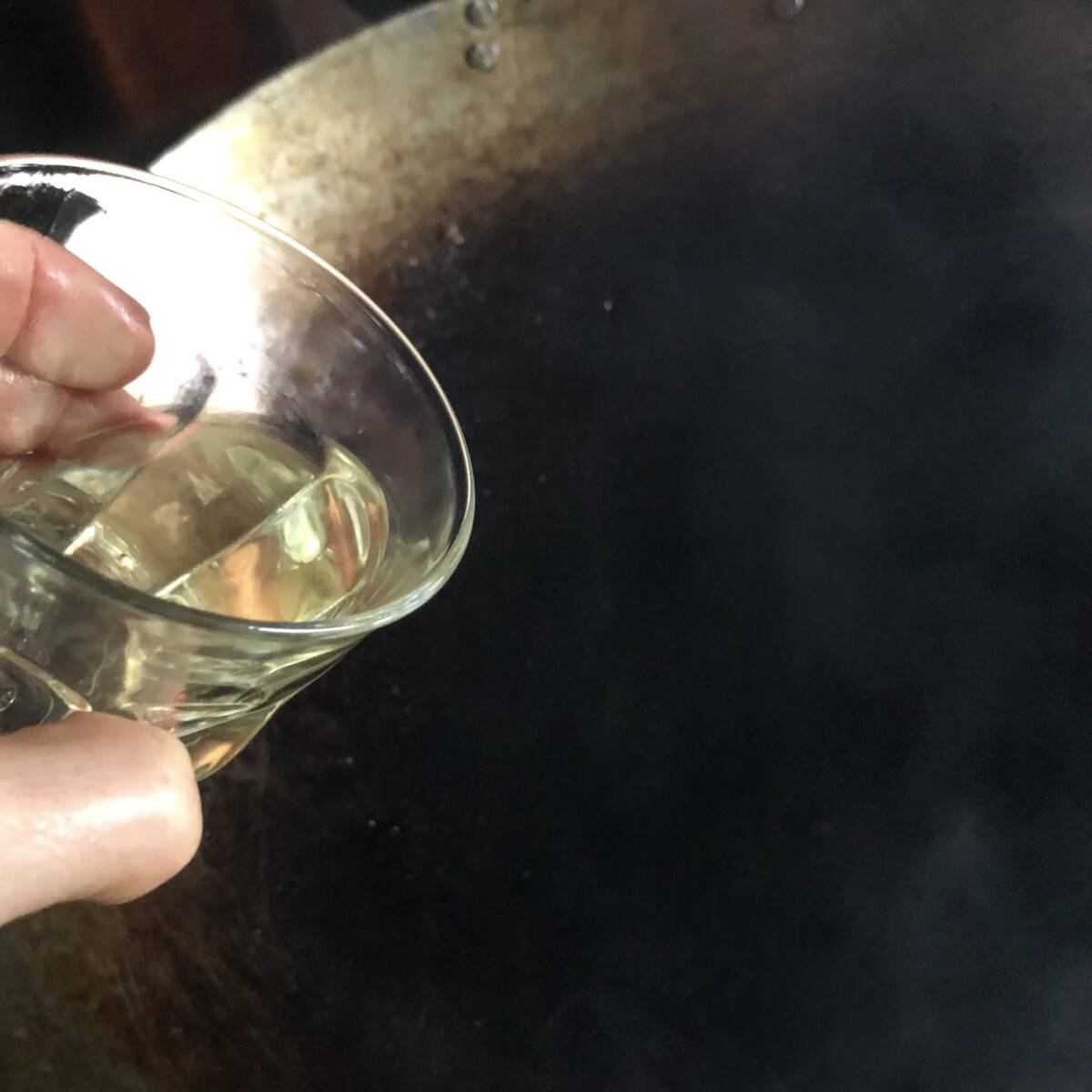 adding a little oil to the wok