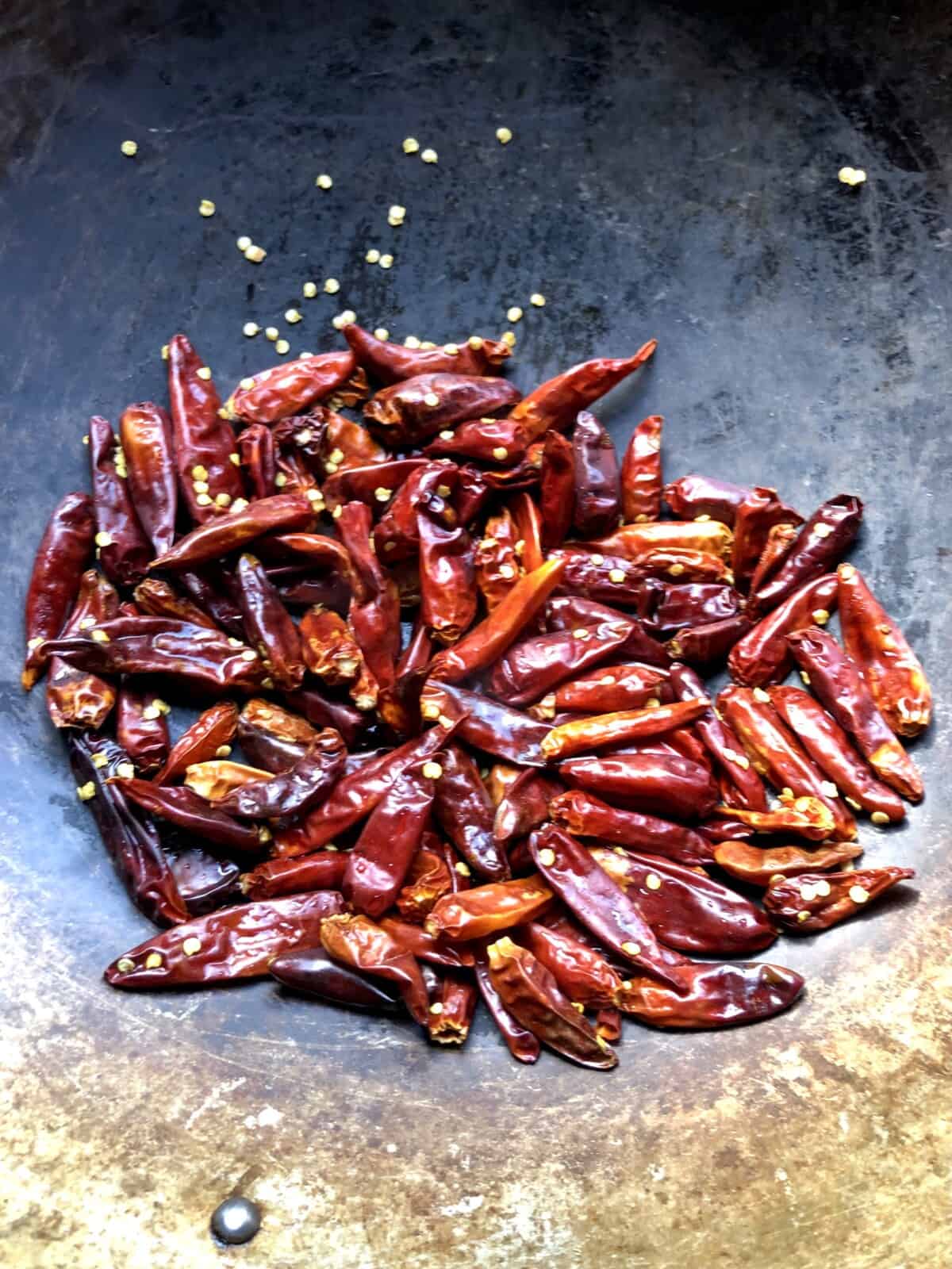 Dried Facing Heaven chilis after being rinsed and added to a wok
