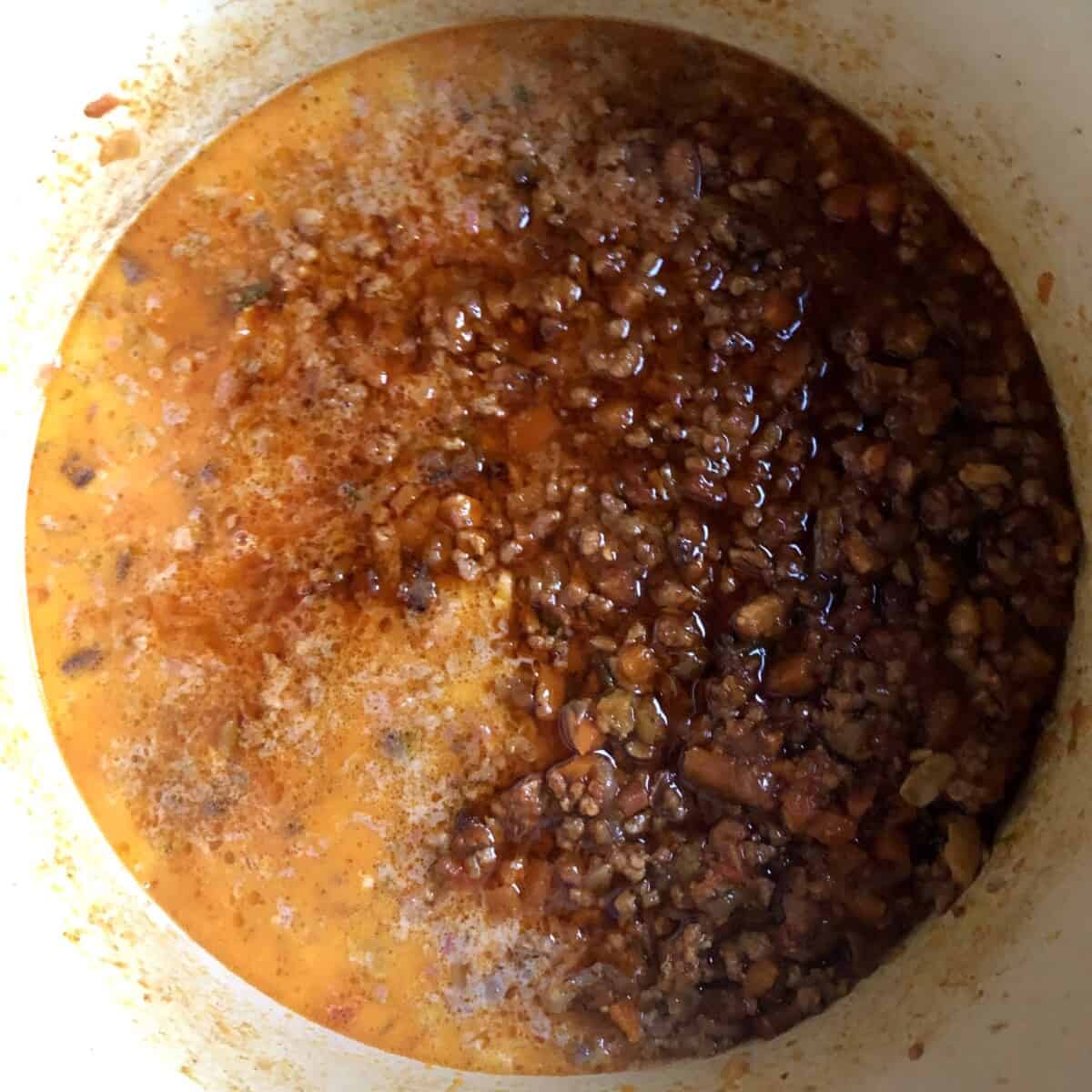 a view inside the pot after cooking 2 hours and adding milk which changed the color to bright milky orange-red