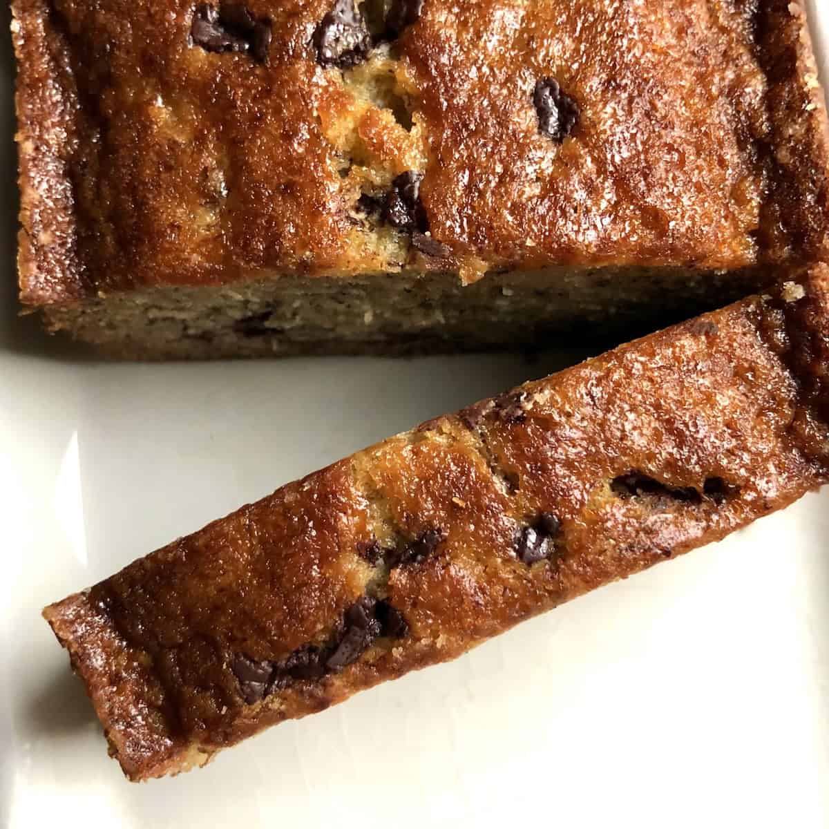 Top down view of a slice of banana bread with chocolate chips with a glistening moist crumb and chocolate throughout, best chocolate chip banana bread recipe.