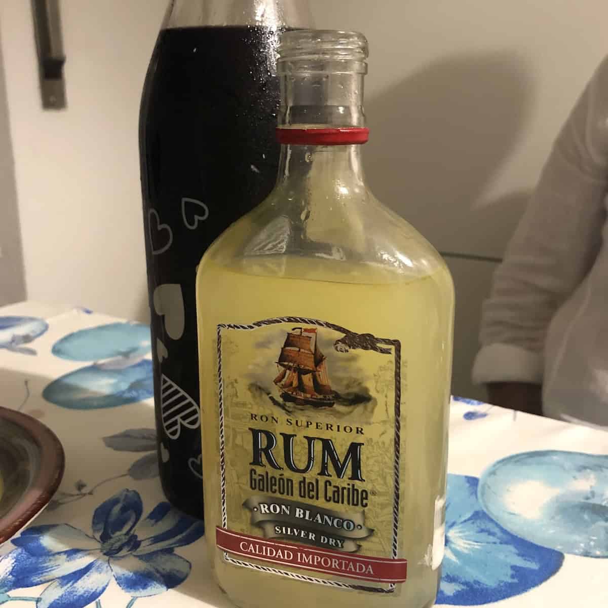 Cousin Rosi's homemade limoncello in a repurposed rum bottle alongside her homemade Ratafià di amarena, a local Abruzzese cherry liqueur made with amarena cherries and Montepulciano d'Abruzzo wine served as an after-dinner Italian digestivo.