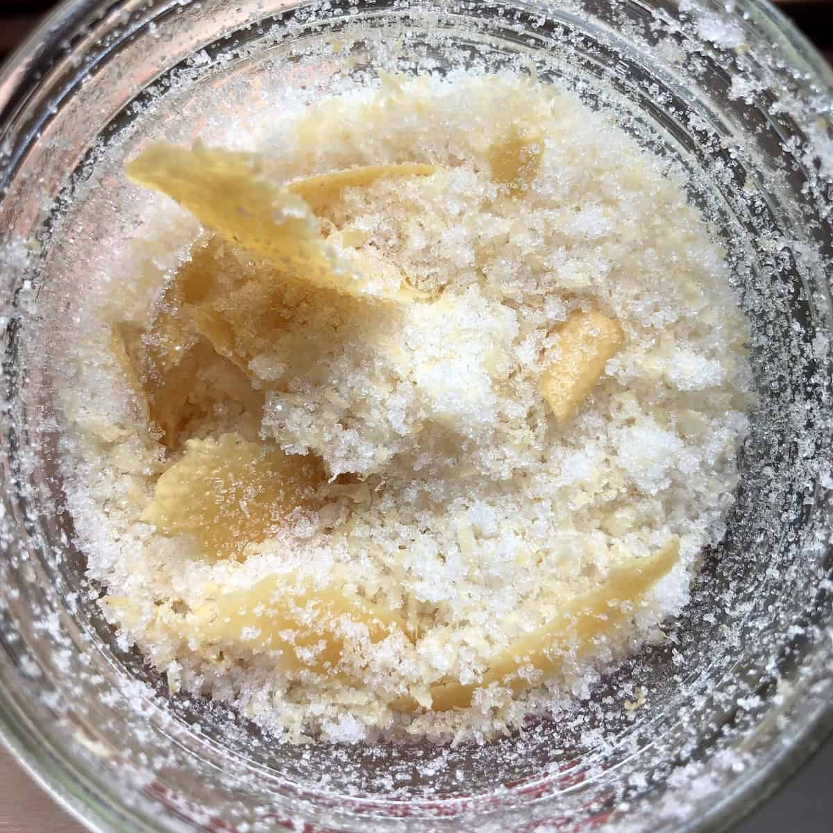 Homemade limoncello sugar made from leftover lemon peels after making limoncello, a zero-waste way to reuse limoncello ingredients for a lemon-flavored sugar.
