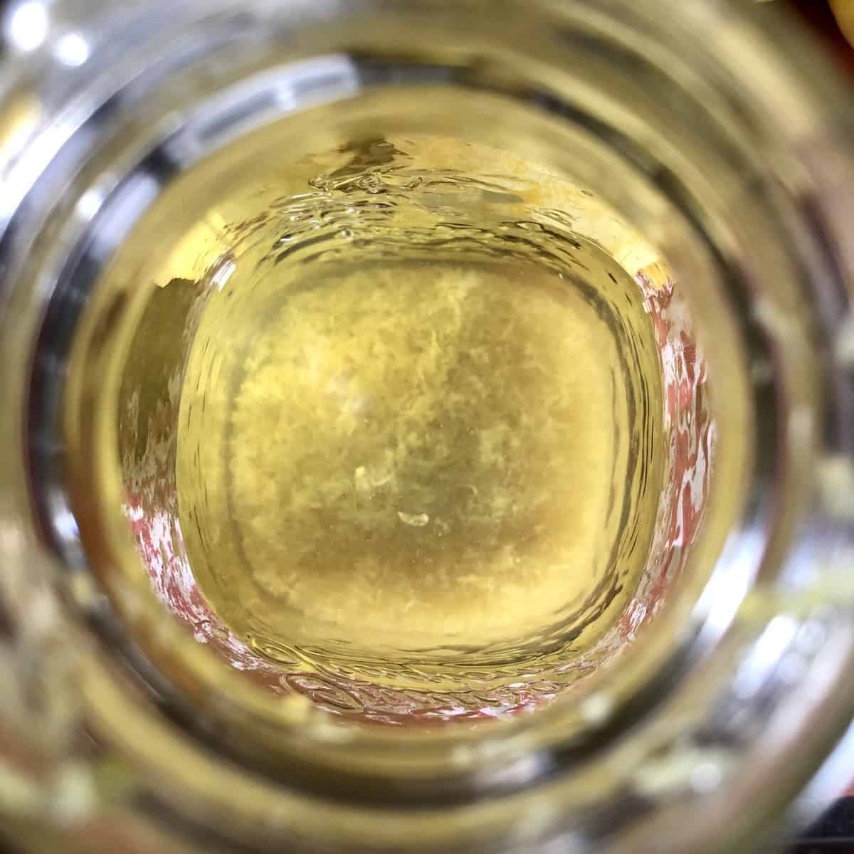 Pure grain alcohol added to the jar of lemon zest for the limoncello infusion, limoncello recipe everclear or high proof alcohol step for making limoncello from scratch.
