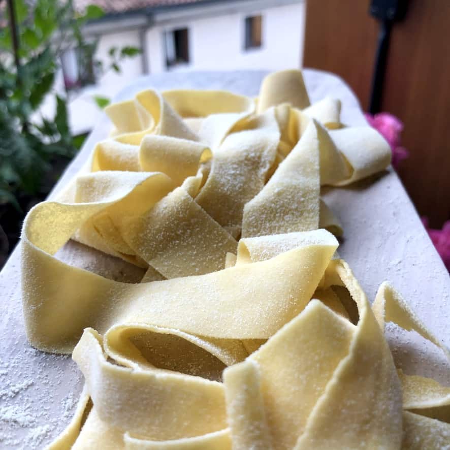 ribbons of homemade papperdelle on a marble tray