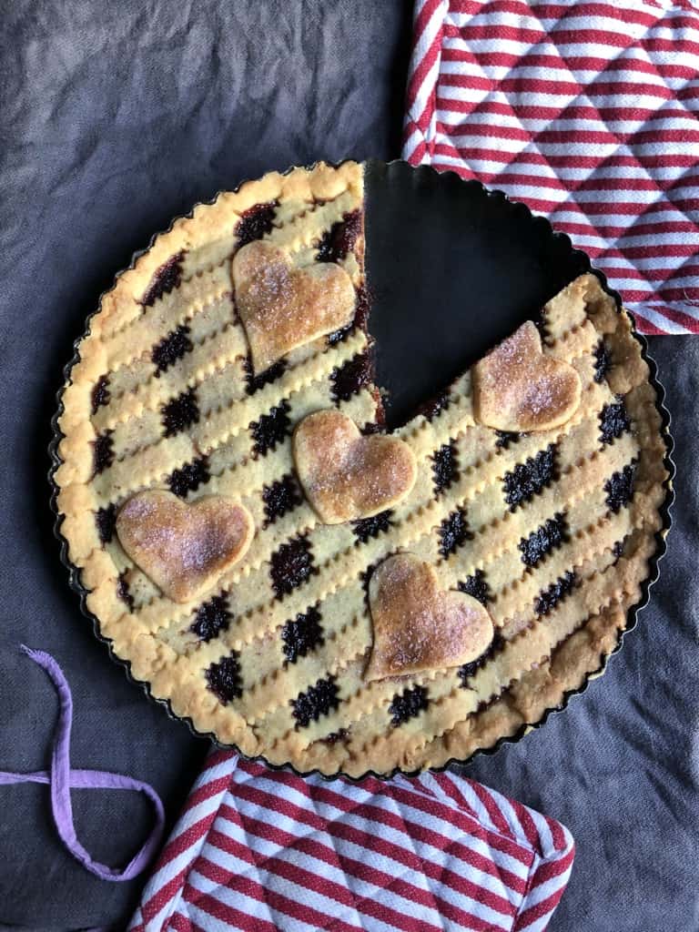 italian cherry jam tart with two pieces removed