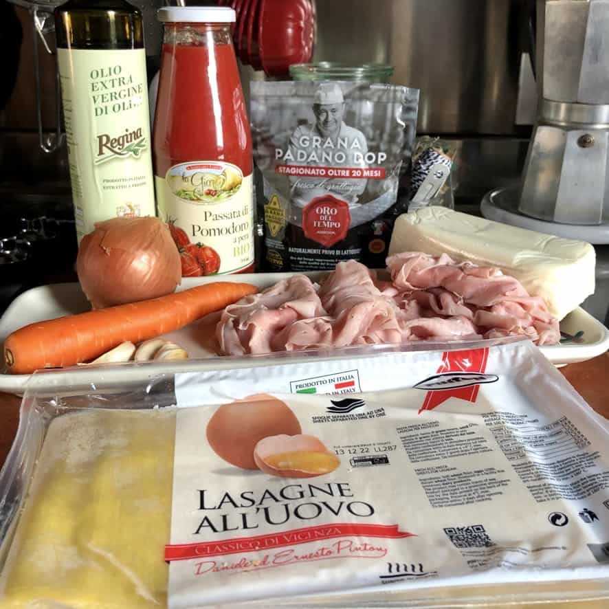 prosciutto cotto lasagna ingredients on a cutting board