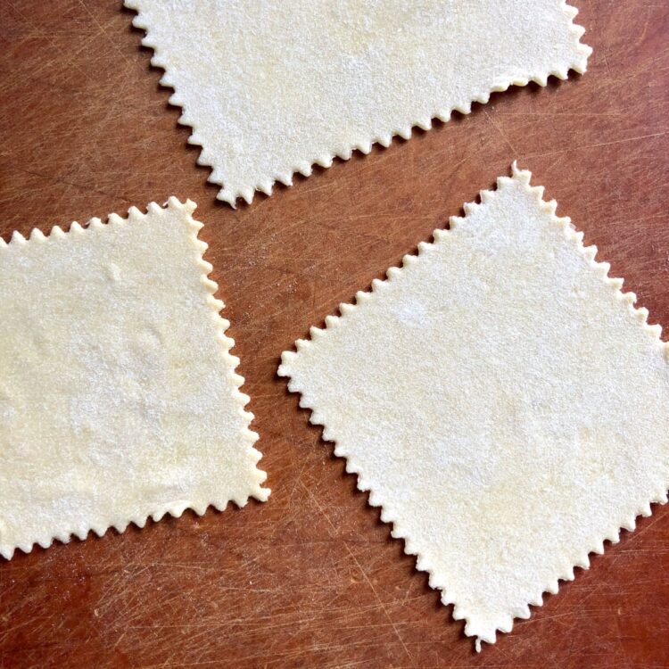 zigzagged square wonton wrappers cut out and ready to be filled