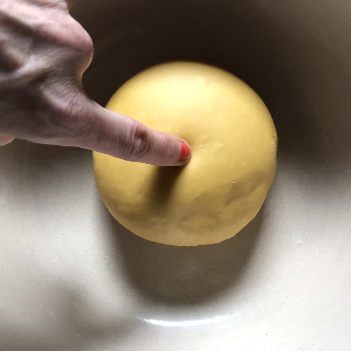 poking the dough round with my finger to see if it leaves a dent