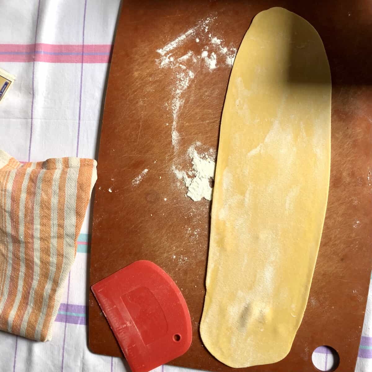 a wide thin sheet of pasta ready to be cut into desired shape