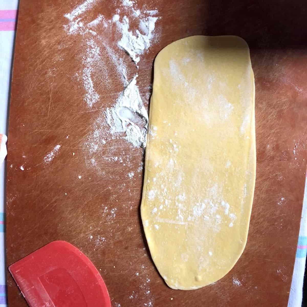 Rolled semolina and 00 flour pasta dough on a cutting board, best pasta mixture semolina and 00 flour.
