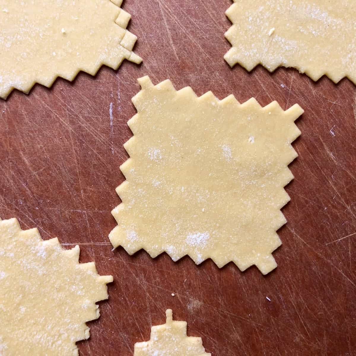 Small squares of semolina and 00 flour pasta dough cut and ready to fill, pasta recipe with semolina and 00 flour.