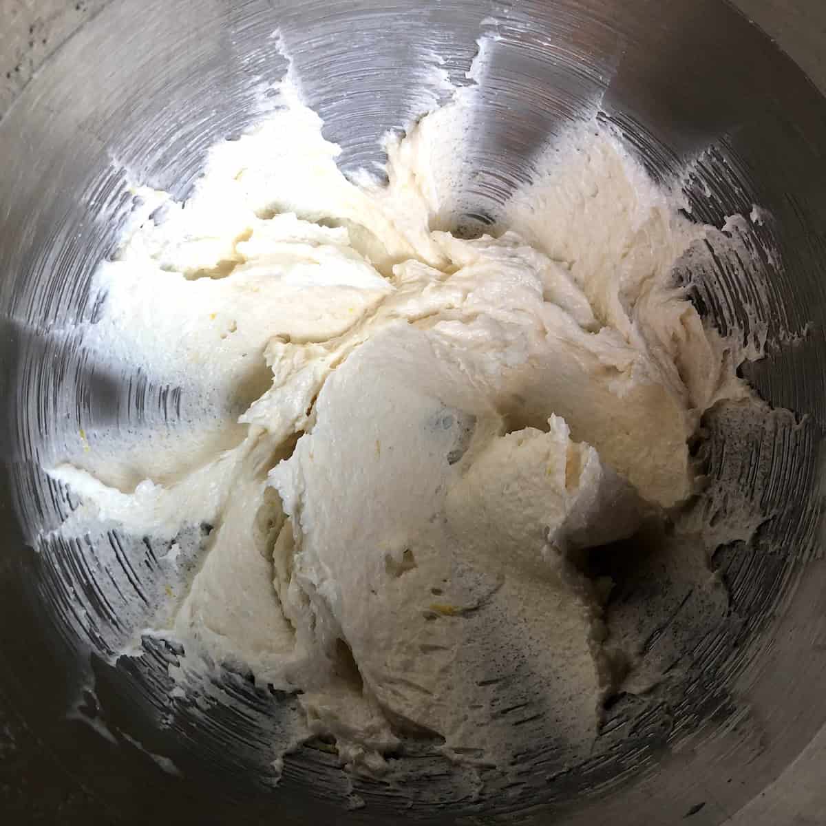 Correctly creamed butter and sugar mixture showing light and fluffy texture for pasta frolla, demonstrating what Italian crostata dough should look like before adding eggs.