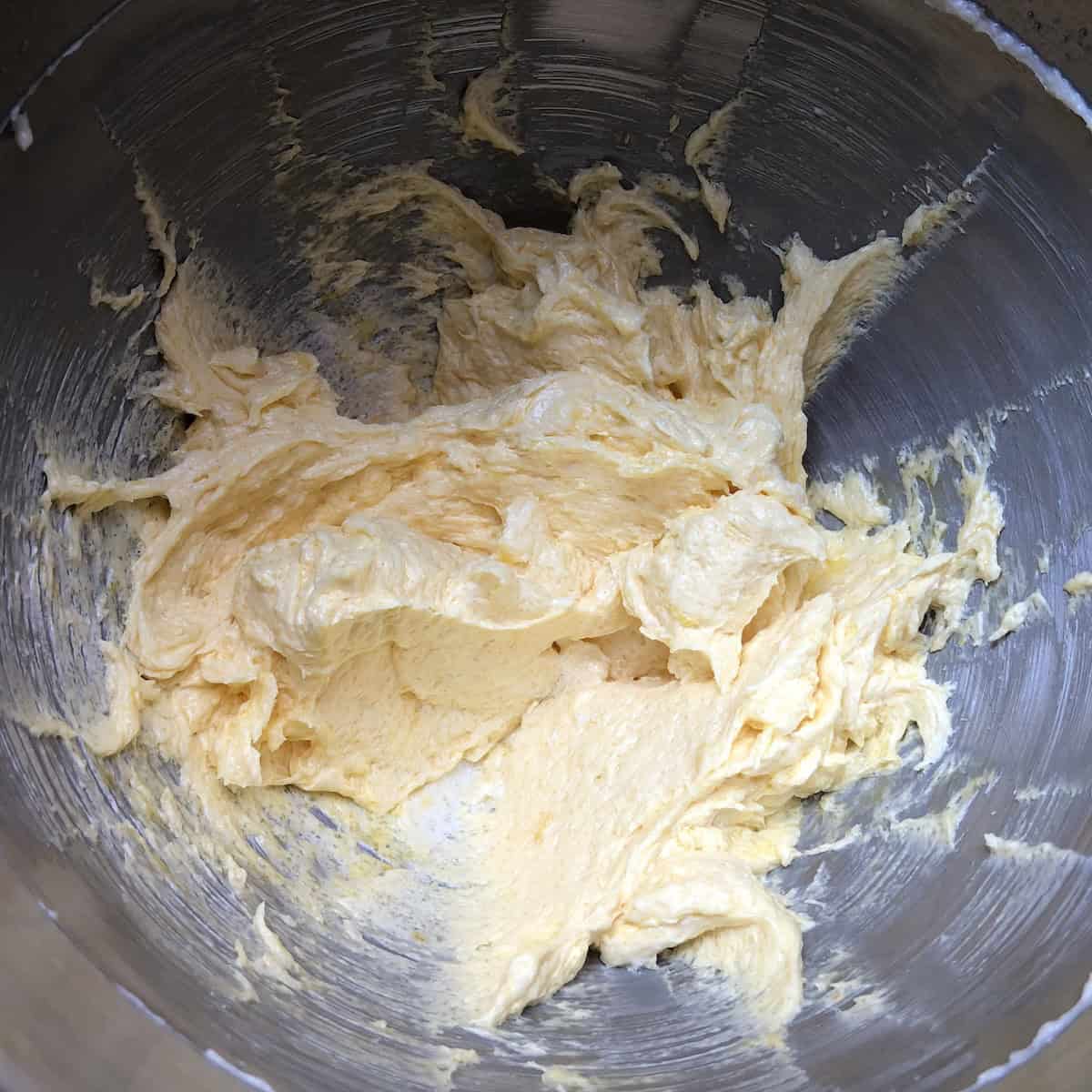 inal wet ingredients for pasta frolla fully combined and ready for flour addition, showing smooth creamy texture of Italian crostata dough base before dry ingredients are folded in.