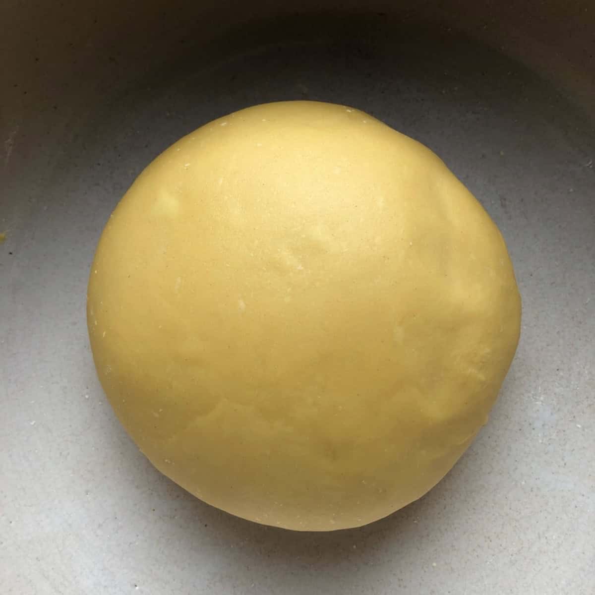 A fully rested semolina and 00 flour pasta dough with a rich color and sheen, best semolina and 00 flour pasta recipe dough after resting.