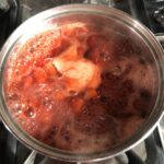 a thicker and more foamy boiling strawberry jam mixture