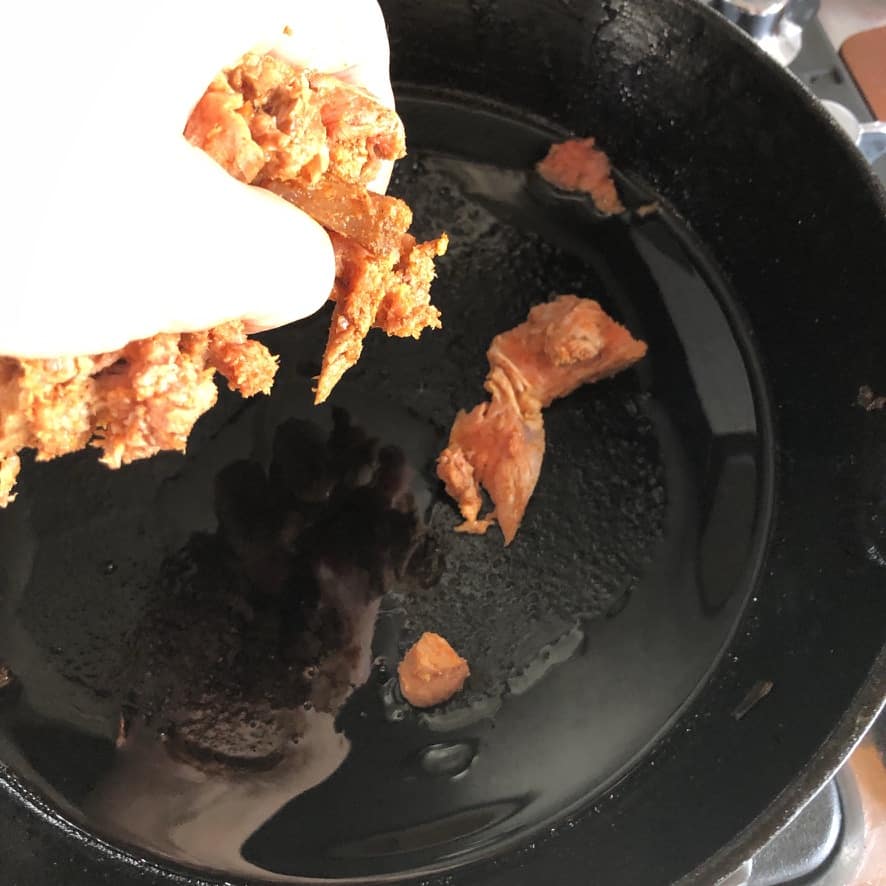 adding the seasoned beef to the empty hot skillet